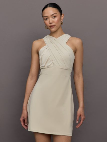Model wears a khaki cross front Cinched waist mini dress.