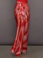 Model wears a multicolored red silky long skirt that ties at the waist.