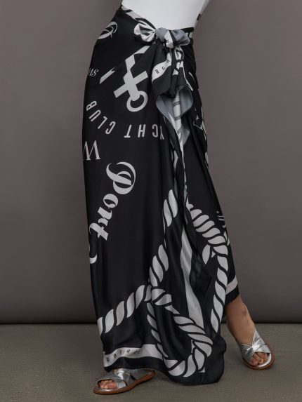 Model wears a black and white printed long silky skirt tied at waist. 