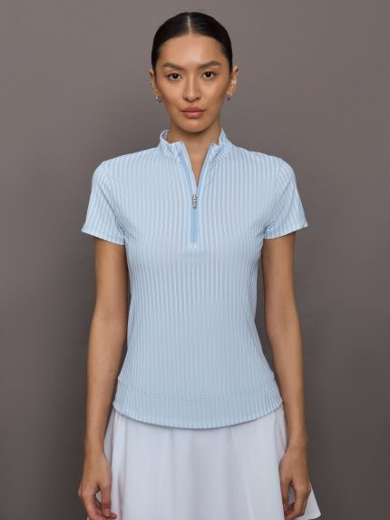 Woman wearing a light blue pinstriped short-sleeve shirt with a quarter zip.