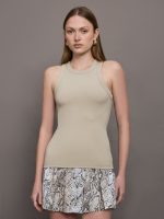 Model wears a taupe colored tank top.