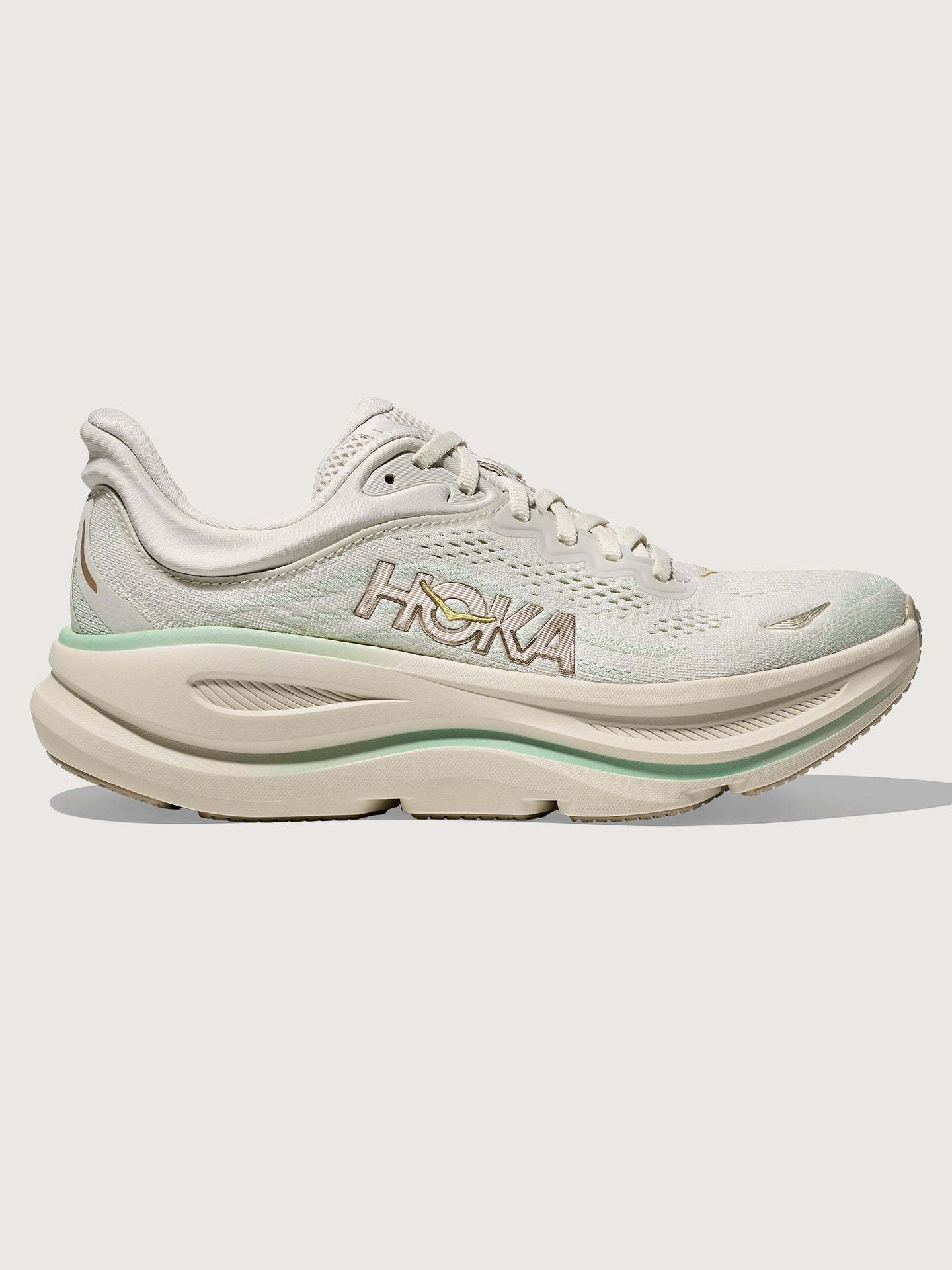HOKA-1162012-IVRYNEOGRN-W-Bondi-9-color-Truffle-Salt-Sea-Glass-Edit Chunky soled white Hoka running shoe with pastel green trim.
