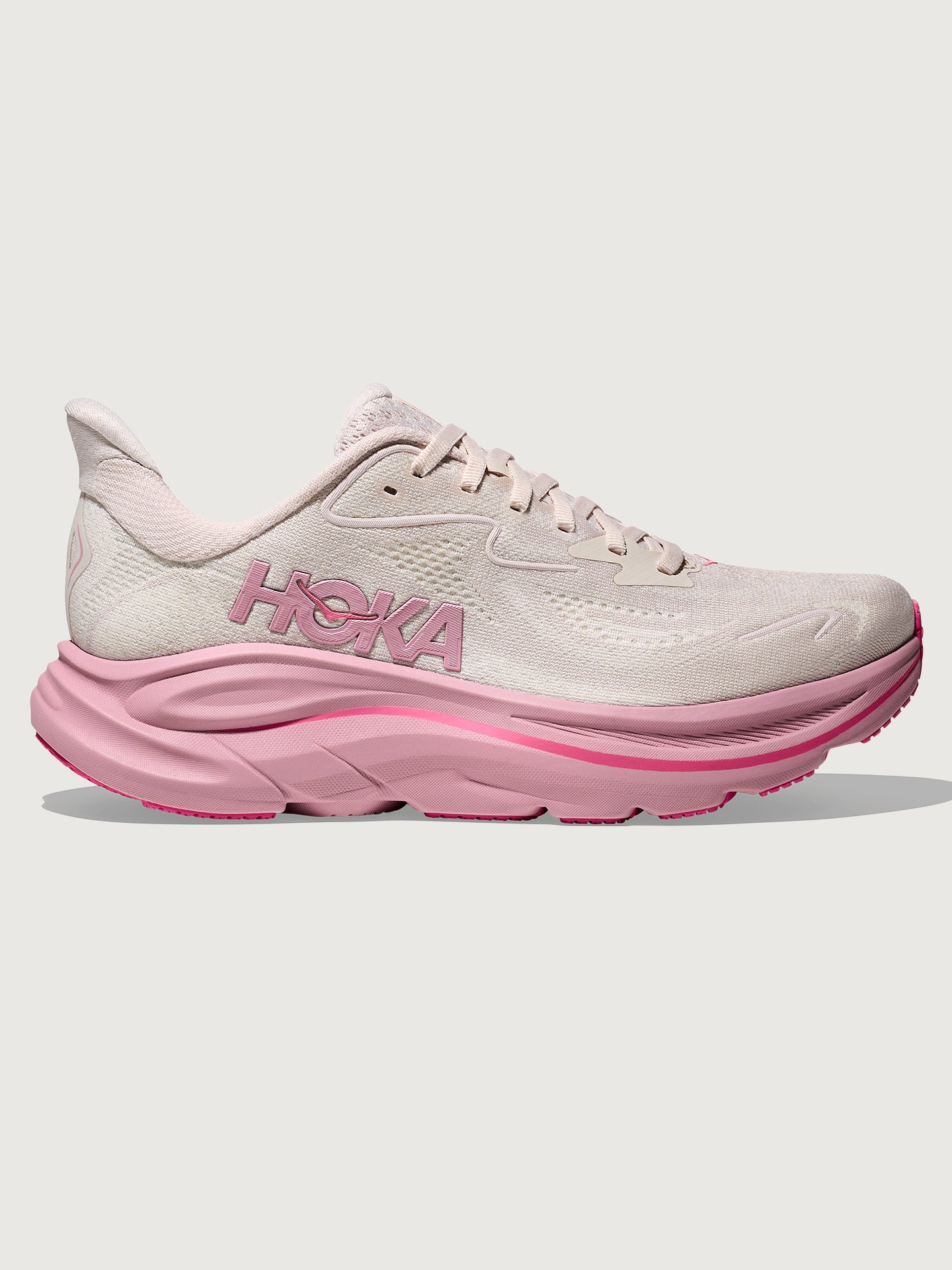 HOKA-1162031-PNKPINMED-W-Clifton-10-color-Rose-Cream-Dried-Rose-Edit_9cfc783e-514a-42f6-b4f7-87ca5f086cf1 Pink Hoka running shoe with chunky sole.
