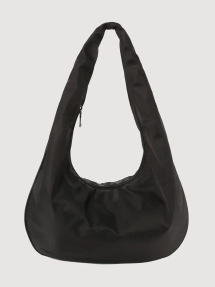 A black matte twill tote bag with a shoulder strap and a zipper outer pocket.