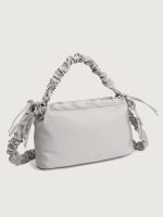 Gray handbag with ruched handle on a light gray background
