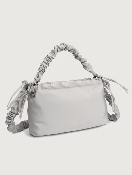 Gray handbag with ruched handle on a light gray background
