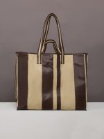 Beige canvas tote bag with black leather bindings, two straps, and an inner pocket.
