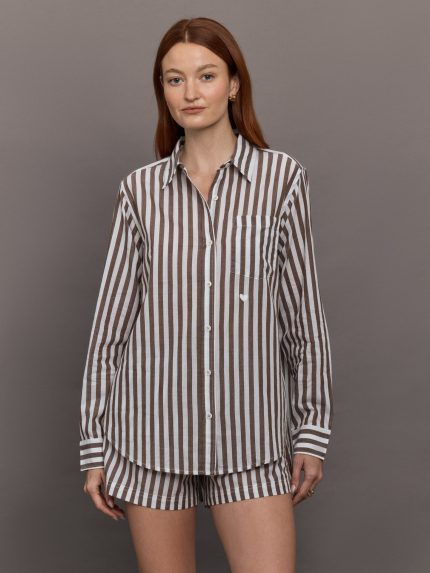Model wears brown and white striped button-down shirt with a relaxed fit, long sleeves.
