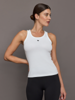 Model wears a white Kerri Rosenthal tank top with a slim fit and a small black heart detail in the upper center.