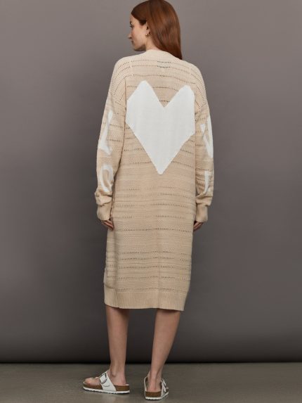 Model wears long, lightweight duster-style sweater in a natural beige tone.