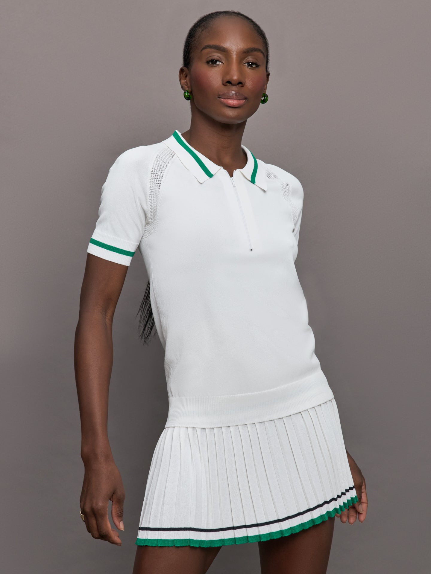 LTSP-SWT020C-WHTGRNDRK-Jersey-Polo-color-White-with-Green-Trim_1199-Edit Model is wearing a short sleeve collared polo in white, with green trim and a quarter zip.