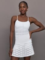 Model wears a lightweight white tank with sheer patterned detailing perfect for tennis.