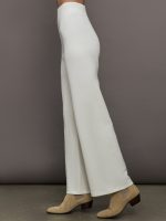 Model wears a pair of high waisted white knit wide leg pants.