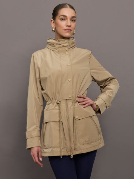 Model is wearing a tan colored rain jacket with a cinched waist.