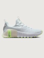 White athletic shoe with neon green sole.