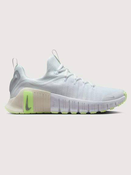White athletic shoe with neon green sole.
