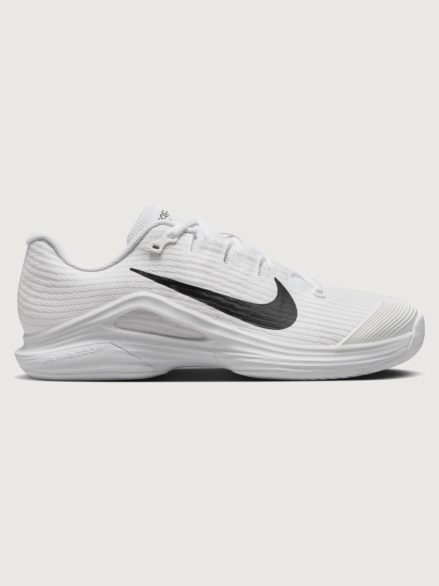 NIKE-FV5554-100-WHTBLK-Nike-Vapor-12-color-White-Black-Summit-White6-Edit White athletic shoe with black swoosh logo on a white background