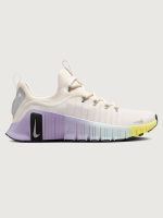 White sneaker with purple sole and yellow accent on a white background