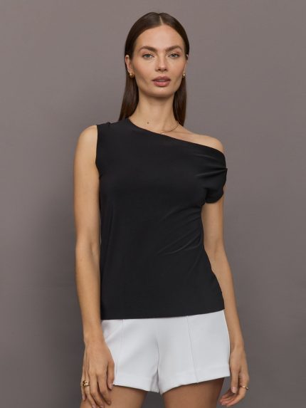 Model wears black short-sleeve top with a drop shoulder design.     