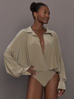 Model wears a light brown long sleeve bodysuit.