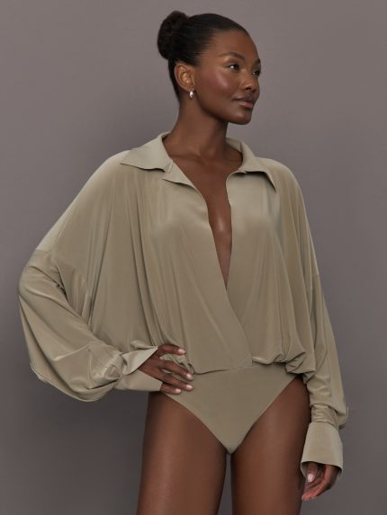 Model wears a light brown long sleeve bodysuit.