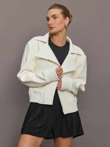 Model wears an oversized white bomber jacket.