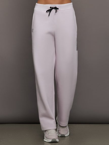 Model wears a pair of light purple sweatpants with black drawstring.