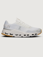 White and beige performance sneakers with a low silhouette and cushioned sole.