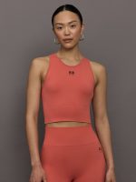 Model wears a sleeveless seamless brick colored cropped tank.