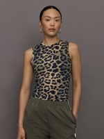 Model wears a full length leopard print patterned sleeveless muscle tank.