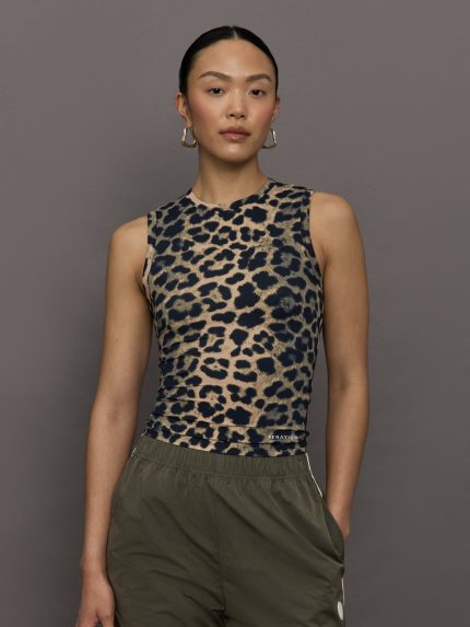 Model wears a full length leopard print patterned sleeveless muscle tank.