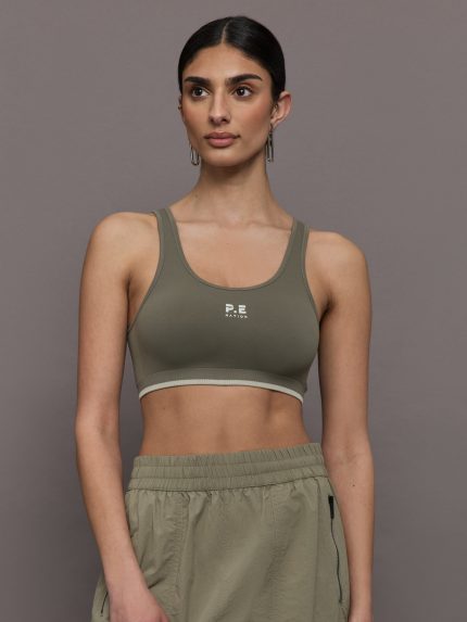 Model wears an olive/khaki scoopneck sports bra. 