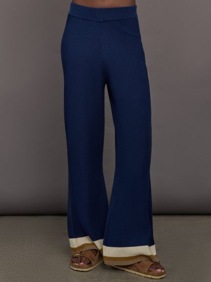 Model wearing Navy blue pants with beige trim.