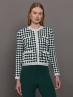 Model wears a green and white patterned cardigan.