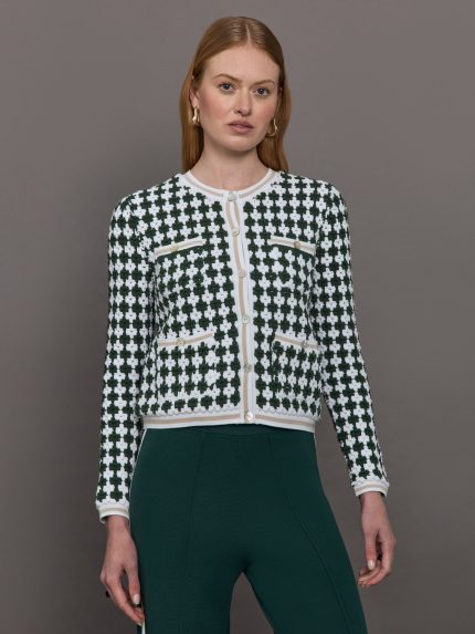 Model wears a green and white patterned cardigan. 