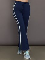 Model wears navy blue flare pants with a mid-rise waist and a fitted silhouette through the hips, gradually flaring out at the legs.