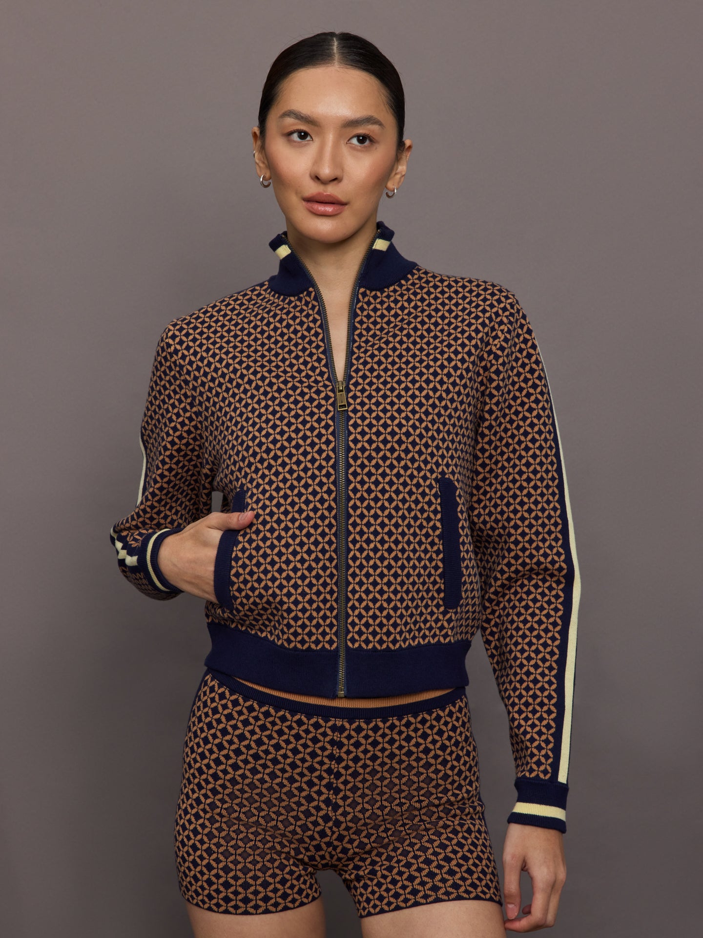 THEU-USW225097-MULTIMULTI-Crossroad-Margot-Knit-Jacket-color-Geo_1106-Edit-Edit Model wearing a geometric patterned track jacket.