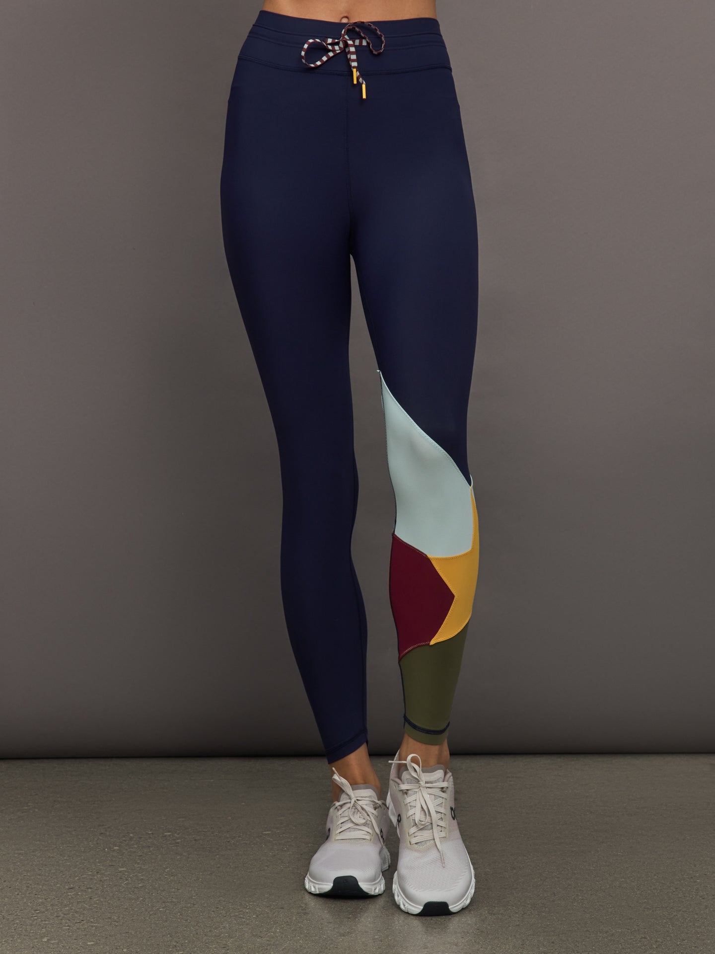 THEU-USW325055-MULTIMULTI-Starbust-25in-Midi-Pant-color-Multi_11178-Edit Model wearing Navy leggings with colorful abstract design.