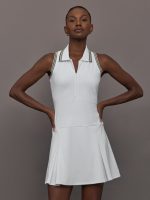 Model wears white sleeveless dress with a fitted bodice and flared skirt, and a collared neck.