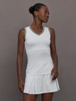 Model wears white tank top with a v-neckline and a fitted design.