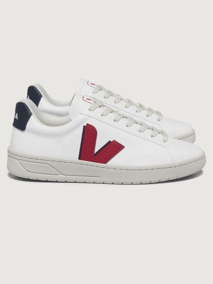 White sneakers with red and blue accents, featuring a lace-up closure and the brand Veja visible on the side.