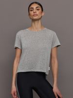 Model wears a heather gray crewneck short sleeved tee shirt.