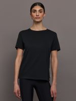 Model wears an oversized classic black tee shirt.