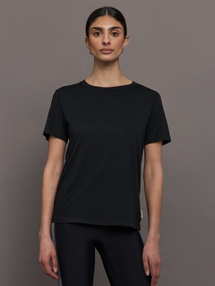 Model wears an oversized classic black tee shirt.