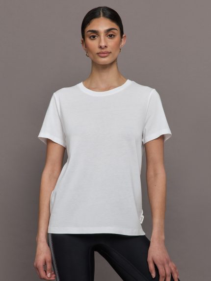 Model wears an oversized classic white tee shirt. 