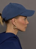 Model wears a dark denim wash blue baseball cap with Y-3 emblazoned on the front.