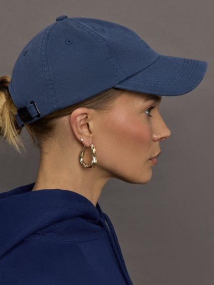 Model wears a dark denim wash blue baseball cap with Y-3 emblazoned on the front.