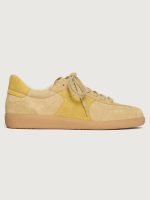 Tan suede low top sneaker with muted yellow detailing.